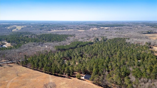 drone / aerial view featuring a forest view