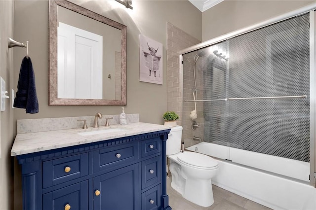 bathroom featuring toilet, shower / bath combination with glass door, tile patterned flooring, and vanity