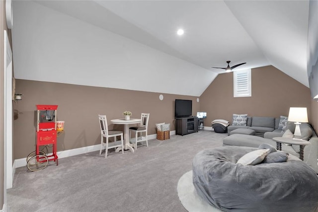 carpeted living area featuring baseboards, vaulted ceiling, and a ceiling fan