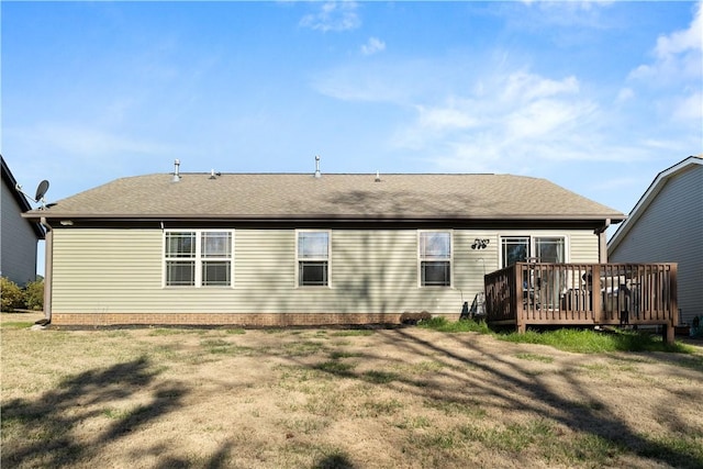 back of property featuring a yard, a shingled roof, and a wooden deck