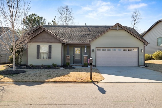 view of front facade with concrete driveway, roof with shingles, and an attached garage