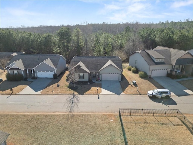 drone / aerial view with a wooded view