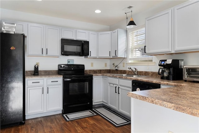 kitchen featuring recessed lighting, a toaster, dark wood-style flooring, a sink, and black appliances