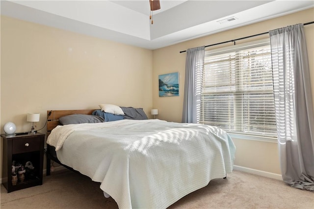 carpeted bedroom featuring baseboards, multiple windows, and visible vents