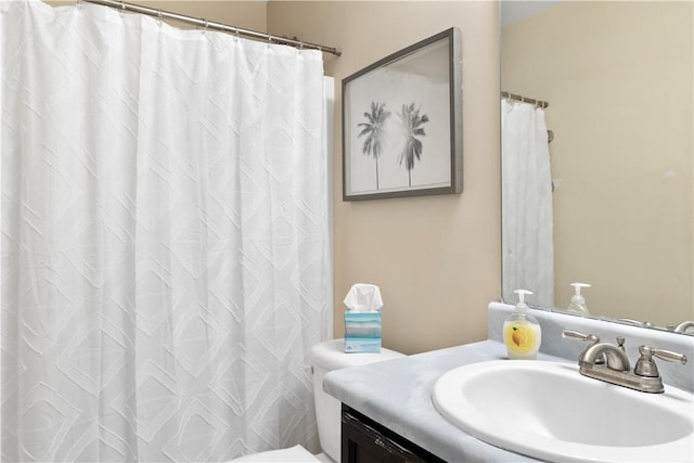 bathroom with toilet, curtained shower, and vanity