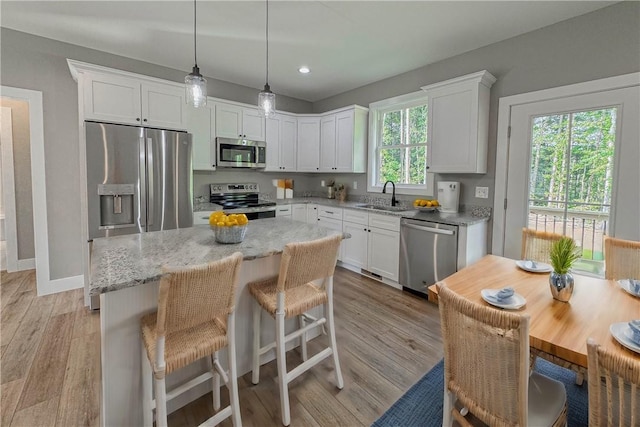 224 Simpson St, Westminster, SC 29693 - kitchen featuring appliances with stainless steel finishes, white cabinets, light wood-type flooring, a center island, and recessed lighting