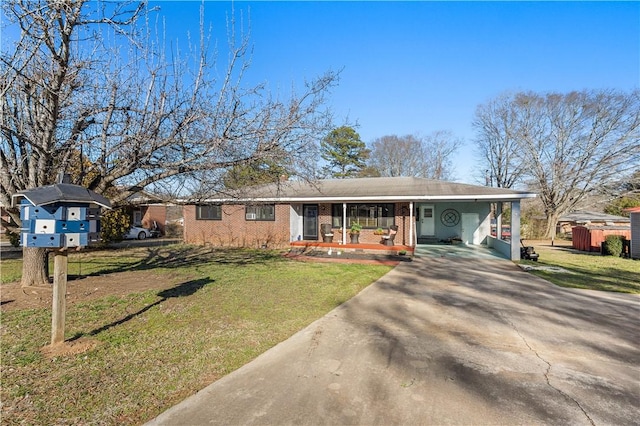 ranch-style home with a carport, a front yard, covered porch, and driveway