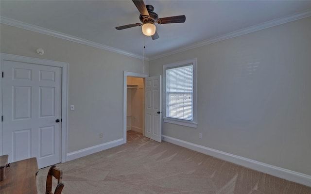 unfurnished bedroom with baseboards, crown molding, and light colored carpet