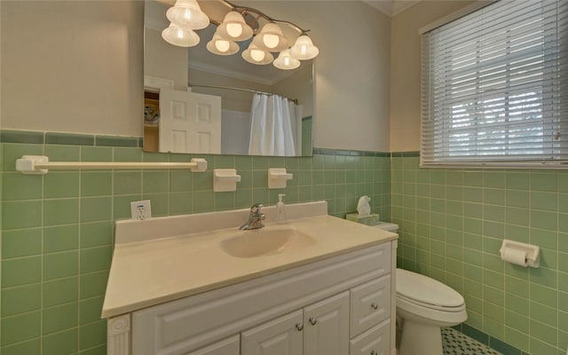 bathroom featuring toilet, ornamental molding, curtained shower, vanity, and tile walls