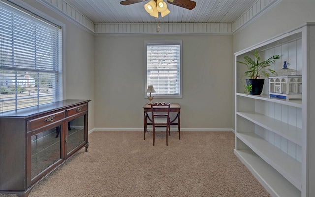 interior space with carpet, baseboards, and ceiling fan