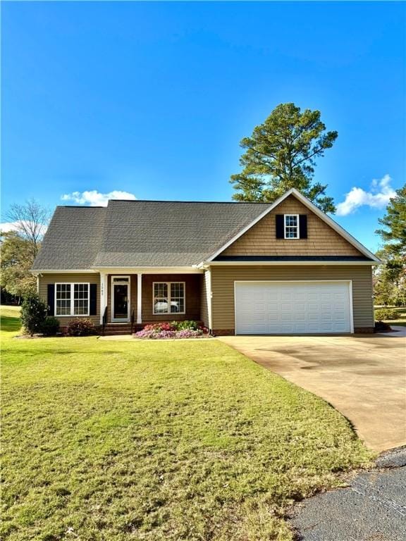 view of front of house featuring driveway, an attached garage, and a front yard