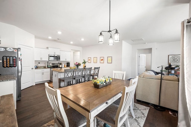 dining space with dark wood-style floors and recessed lighting