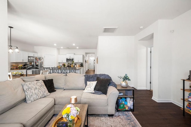 living room with a chandelier, recessed lighting, visible vents, baseboards, and dark wood-style floors