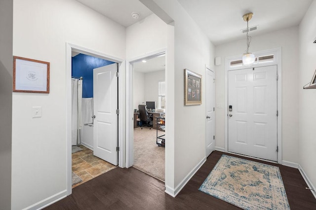 entrance foyer featuring dark wood-style floors, visible vents, and baseboards