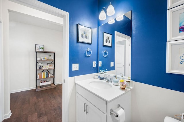 bathroom with wood finished floors and vanity