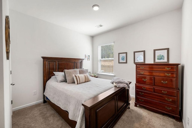 bedroom featuring baseboards, visible vents, and carpet flooring