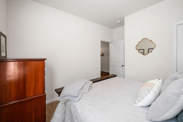 carpeted bedroom featuring baseboards