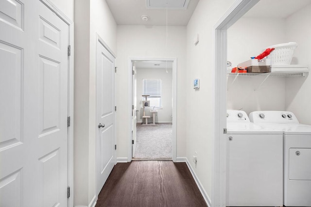 clothes washing area featuring laundry area, attic access, baseboards, washer and clothes dryer, and dark carpet