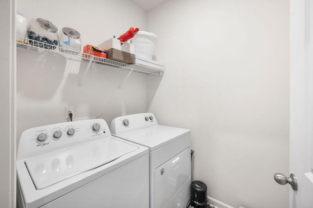 washroom with laundry area, baseboards, and washer and clothes dryer