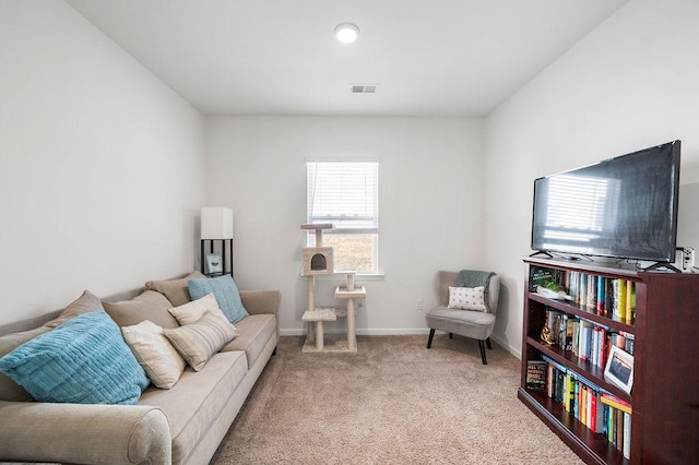 living room with baseboards, visible vents, and light colored carpet