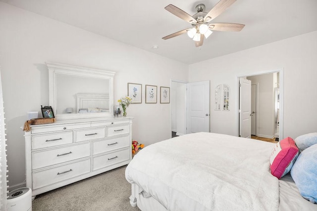 bedroom featuring light carpet and a ceiling fan