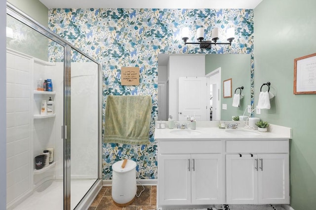 bathroom featuring double vanity, a sink, and a shower stall