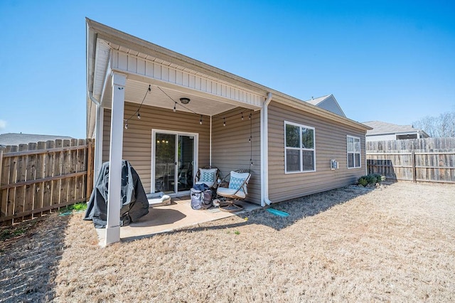 back of house with fence and a patio