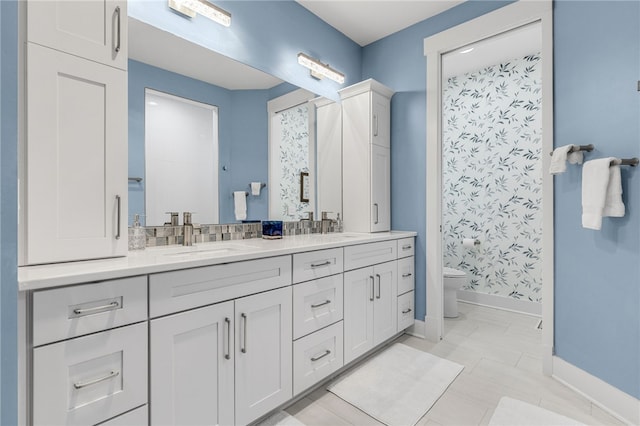 1230 Melton Rd Unit 215, West Union, SC 29696 - bathroom featuring baseboards, toilet, double vanity, and a sink