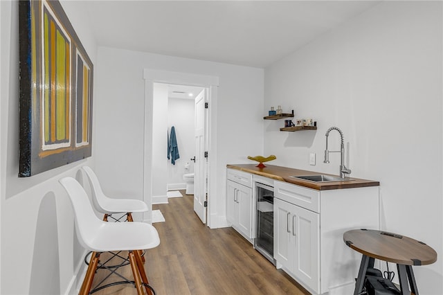 1230 Melton Rd Unit 215, West Union, SC 29696 - bar featuring a sink, baseboards, indoor wet bar, dark wood finished floors, and wine cooler