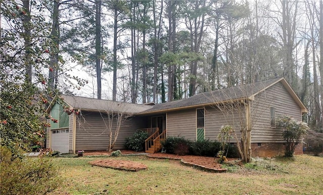 single story home featuring crawl space, an attached garage, and a front yard