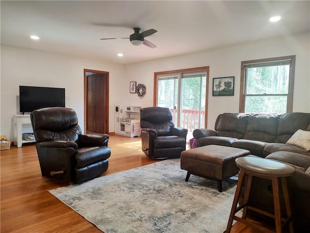 living room featuring plenty of natural light, wood finished floors, and recessed lighting