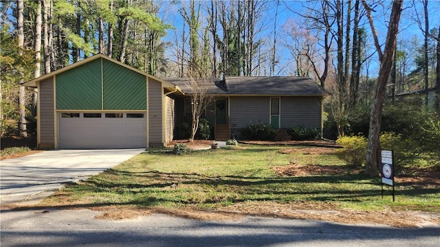 view of front of property featuring concrete driveway, an attached garage, and a front lawn