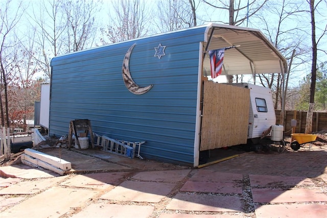 view of home's exterior featuring a detached carport