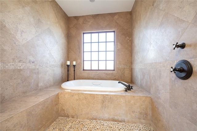 full bath featuring a tile shower and a bath