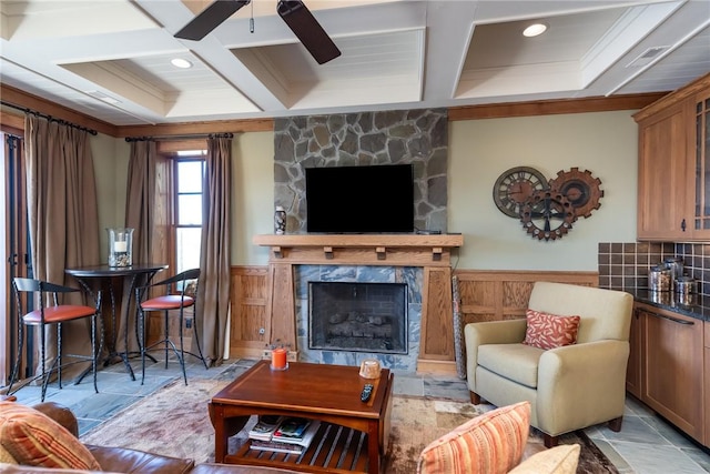 living area featuring a fireplace, coffered ceiling, and beamed ceiling