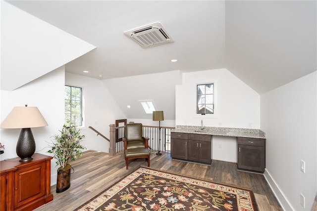 office space featuring vaulted ceiling, dark wood-style flooring, and plenty of natural light