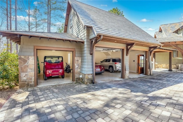 exterior space featuring stone siding and an attached garage