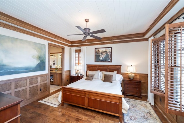 bedroom featuring a wainscoted wall, crown molding, a ceiling fan, wood finished floors, and wooden ceiling