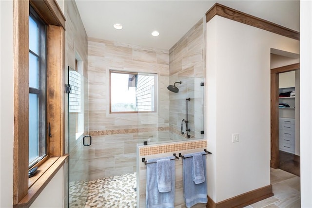 bathroom featuring a stall shower, baseboards, and recessed lighting