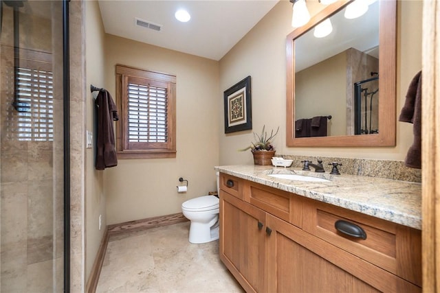 full bathroom featuring visible vents, toilet, a stall shower, vanity, and baseboards