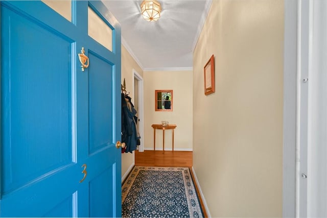 entryway featuring ornamental molding and baseboards