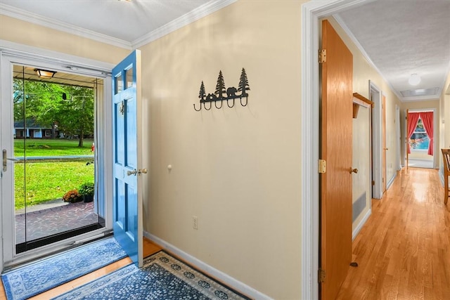 interior space with crown molding, baseboards, and wood finished floors