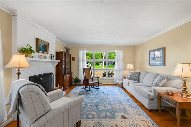 living room with crown molding, a fireplace, and wood finished floors