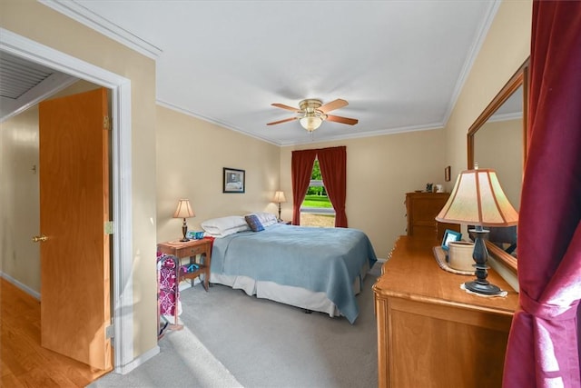 bedroom featuring a ceiling fan, carpet, crown molding, and baseboards