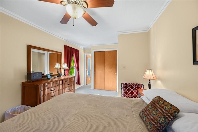 carpeted bedroom featuring a ceiling fan and crown molding