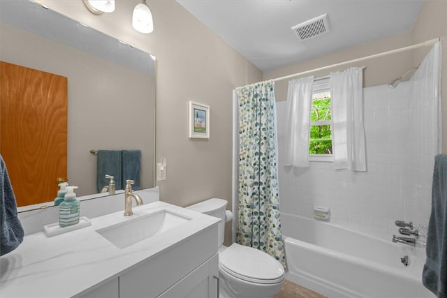 bathroom featuring toilet, vanity, shower / bath combination with curtain, and visible vents