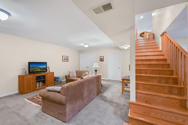 carpeted living area featuring baseboards, stairs, and visible vents