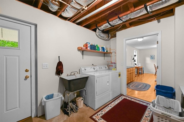 washroom featuring laundry area, light wood-style flooring, and washer and dryer