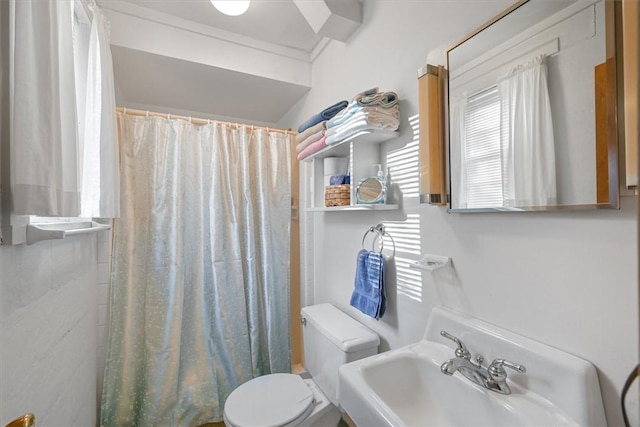 full bathroom featuring curtained shower, a sink, and toilet