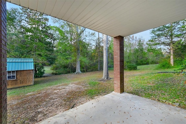 view of patio / terrace featuring an outdoor structure and a storage unit